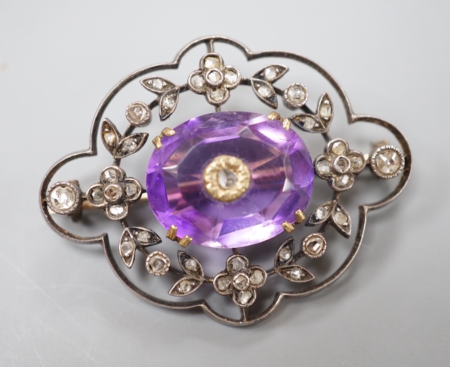 An Edwardian yellow metal, amethyst and rose cut diamond set shaped oval brooch, 34mm, gross weight 5.9 grams.